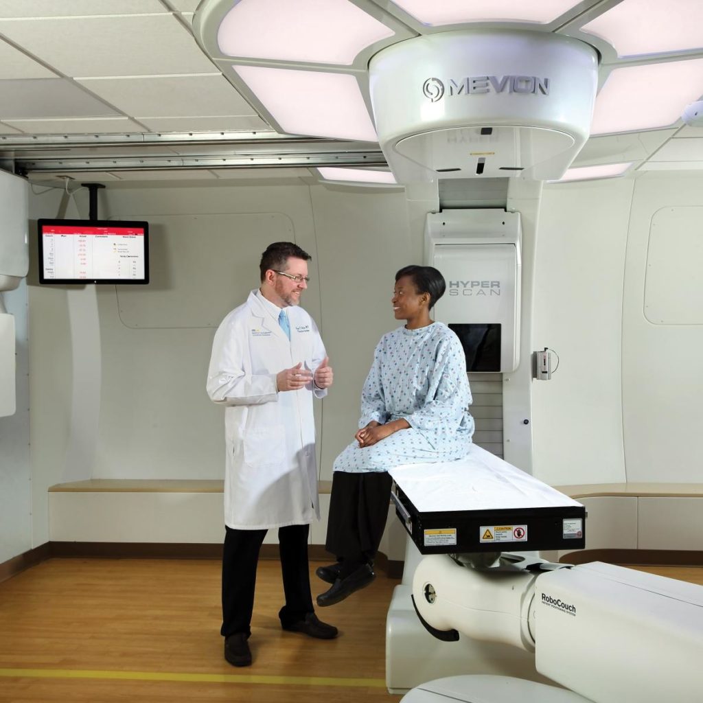 Doctor talking to a patient in a room.